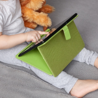 Child with tablet and teddy