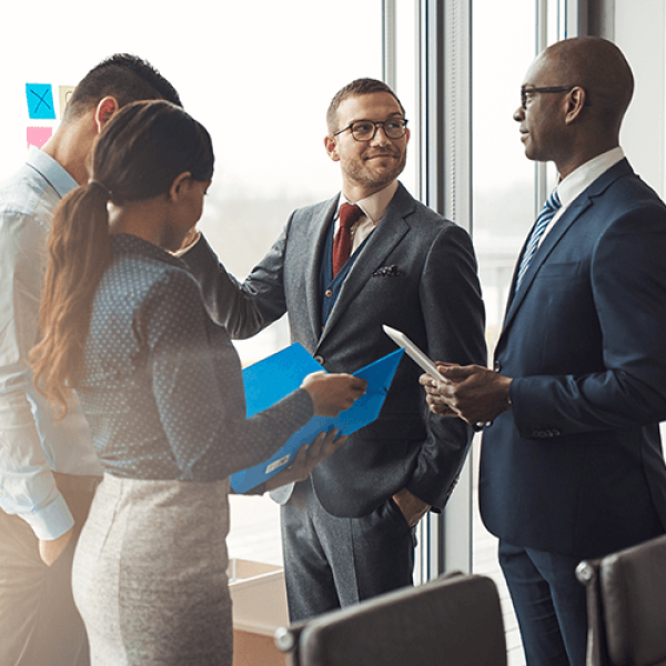 Group of people in business dress collaborating on project